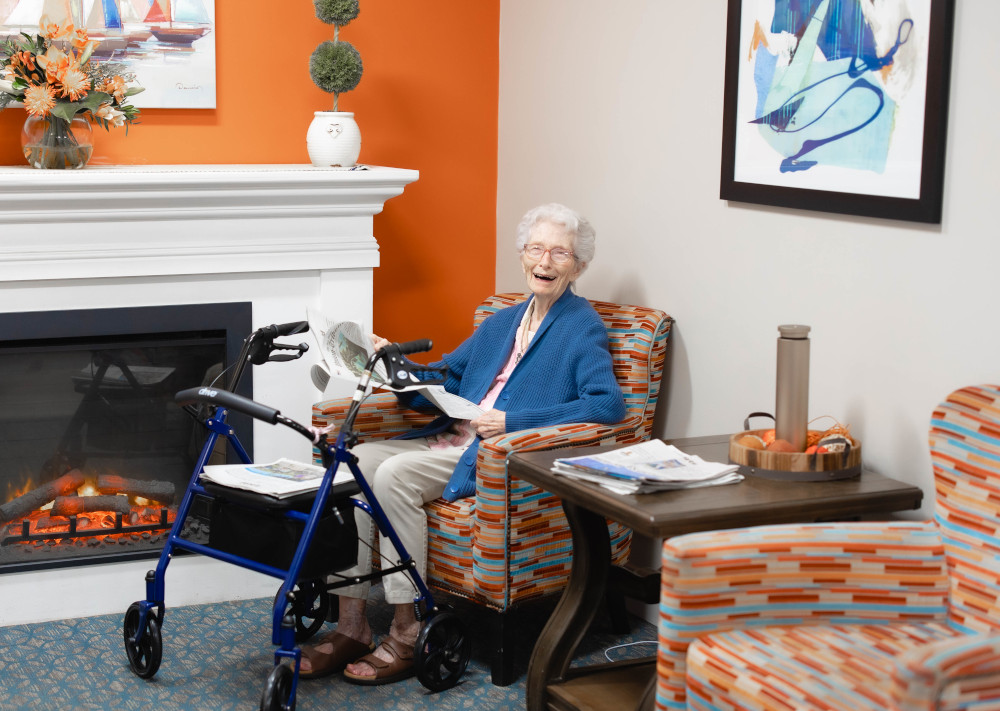 Senior woman by a fireplace